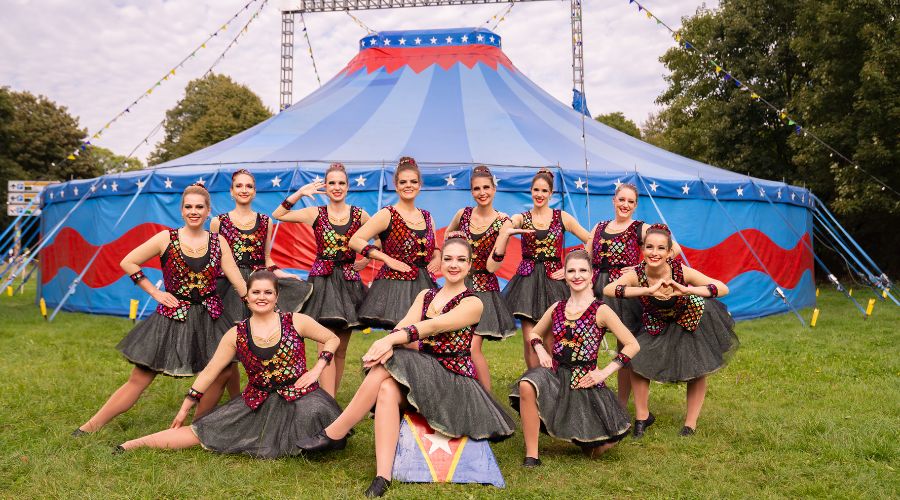 Showtanzgruppe des Kölner Karneval im Zirkuskostüm vor dem Zirkuszelt in Köln-Brühl
